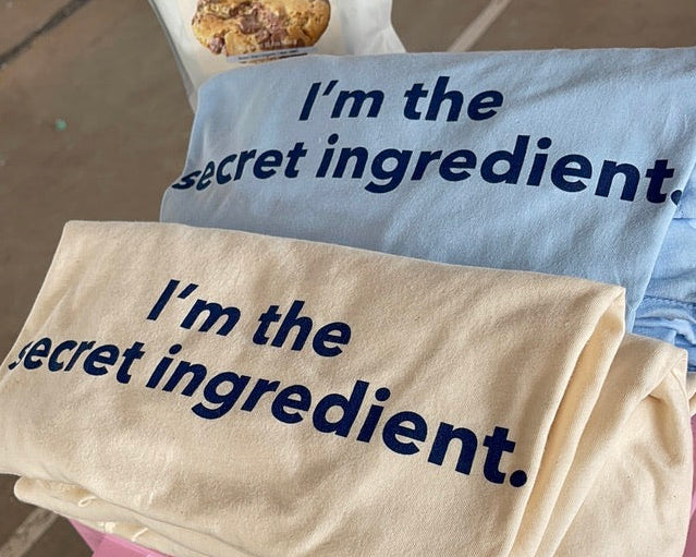 Two TruCrumb shirts with 'I'm the secret ingredient' text.