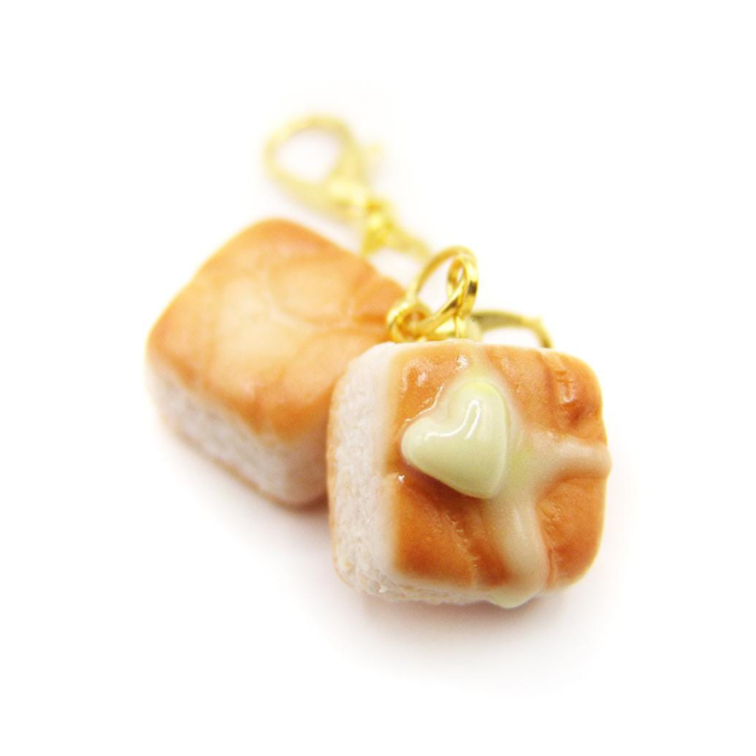 Miniature biscuit charm with a heart butter on a white background.
