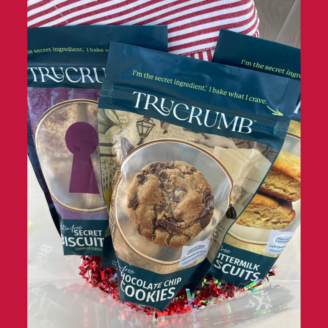 TruCrumb gluten-free cookie and biscuit packages with a red and white striped apron inside a gift bag