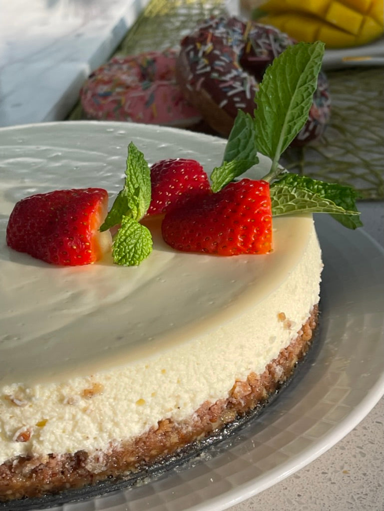 NY Style cheesecake plated with strawberries and mint