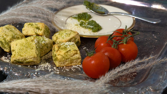 TruCrumb Pesto Biscuitini on a silver platter with tomatoes and cheese
